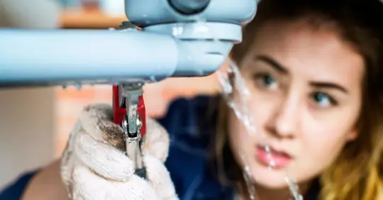 Homeowner fixing broken pipe